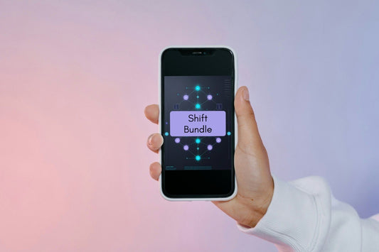 A hand holding a smartphone that displays a digital interface labeled 'Shift Bundle' against a soft pink and purple gradient background.